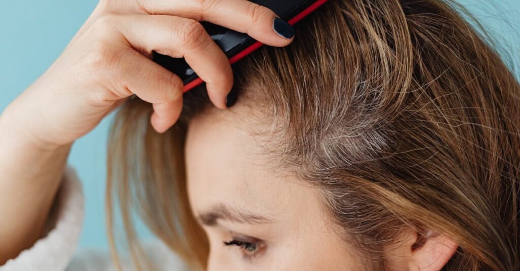 Woman checking her hairline, considering shilajit for hair fall as a natural remedy